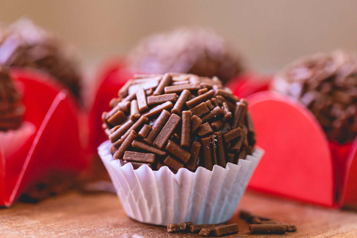 Brazilian Gourmet Brigadeiro on a wooden board in macro photography.